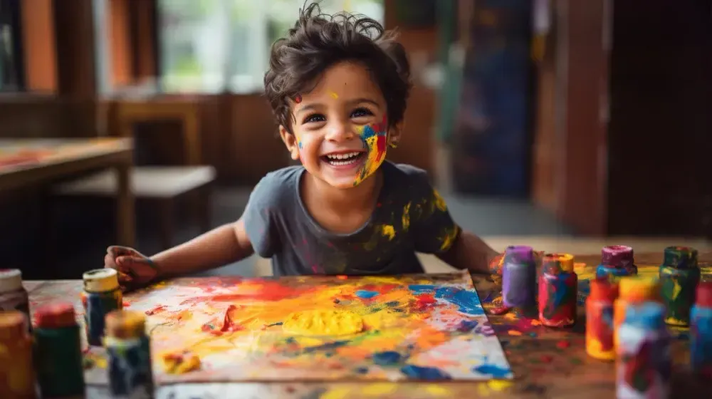 Child painting with colours