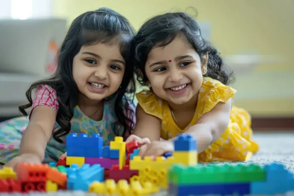 Two girls playing with building blocks at Heilakidz